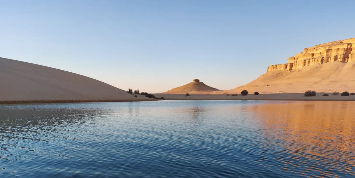 Un lac au pied des dunes et des reliefs de Siwa